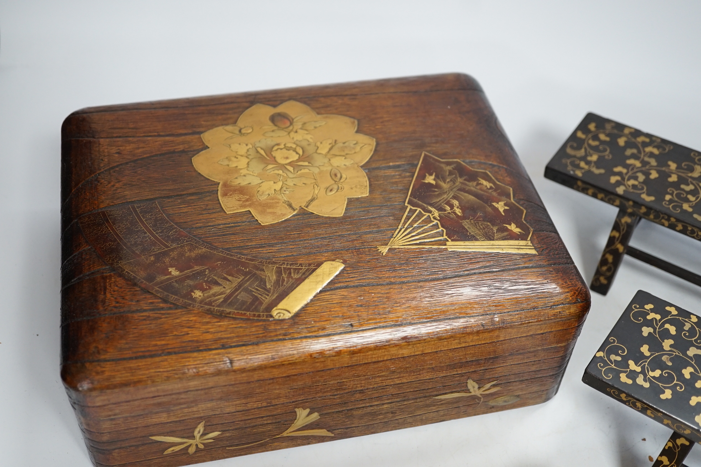 A group of Japanese lacquer wares, comprising pair of miniature benches and two boxes, Meiji period and later, largest 25cm wide